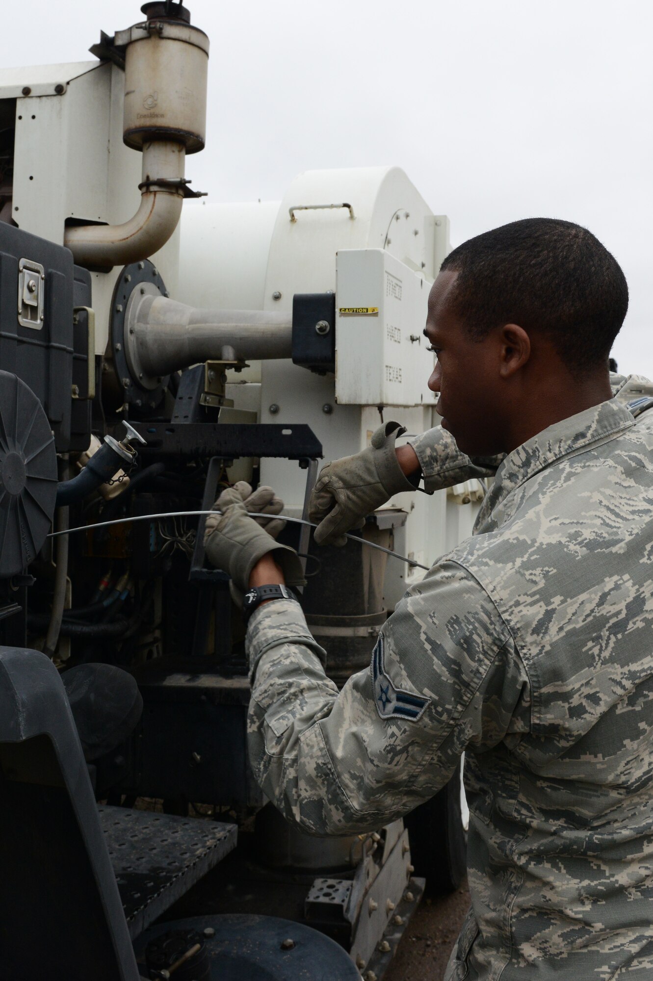 Airman 1st Class Demetrius Smith, 56th Civil Engineer Squadron heavy equipment operator, checks the oil on a street sweeper at Luke Air Force Base, Ariz., Jan. 5, 2016. The street sweepers get utilized primarily for the airfield and secondly for the streets on base. (U.S. Air Force photo by Senior Airman James Hensley)