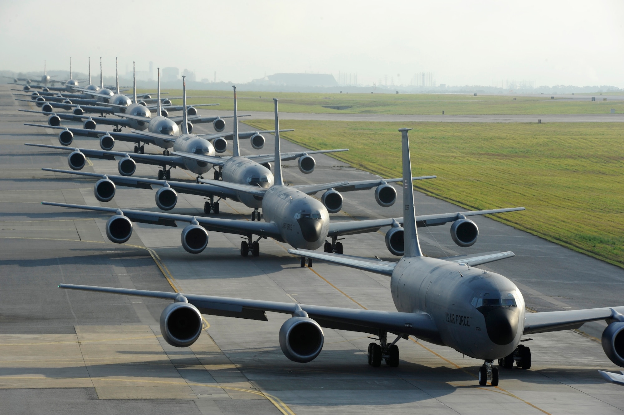 Twelve KC-135 Stratotankers from the 909th Air Refueling Squadron taxi onto the runway during exercise Forceful Tiger on Kadena Air Base, Japan, April 1, 2015. During the aerial exercise, the Stratotankers delivered 800,000 pounds of fuel to approximately 50 aircraft. (U.S. Air Force photo/Staff Sgt. Marcus Morris)