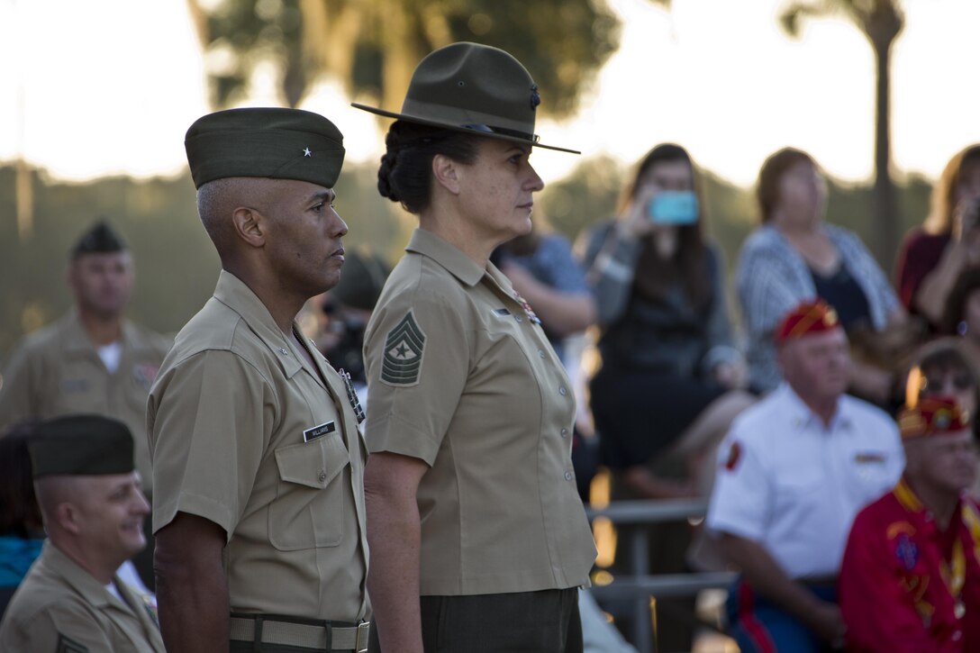 U.S. Marines Brig. Gen. Terry V. Williams, left, the commanding general, and Sgt. Maj. Angela M. Maness, the sergeant major both of Marine Corps Recruit Depot (MCRD) Parris Island (PI) participate in morning colors during the visit of Commandant of the Marine Corps, Gen. Robert B. Neller, at MCRD PI, S.C., Oct. 16, 2015. Neller outlined the Corps' current priorities, expectations, listened and answered questions during his visit. (U.S. Marine Corps photo by Sgt. Gabriela Garcia/Released)