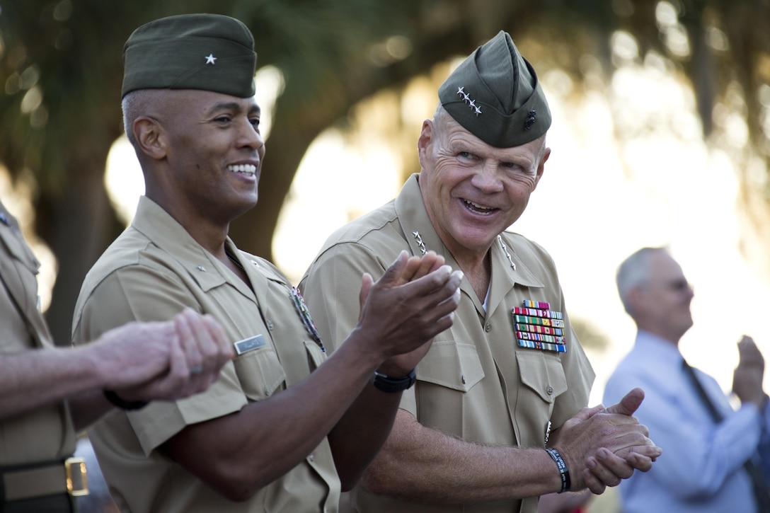 Commandant of the Marine Corps, Gen. Robert B. Neller, right, and Brig. Gen. Terry V. Williams, left, the commanding general of Marine Corps Recruit Depot (MCRD) Parris Island (PI), clap during morning colors at MCRD PI, S.C., Oct. 16, 2015. Neller outlined the Corps' current priorities, expectations, listened and answered questions during his visit. (U.S. Marine Corps photo by Sgt. Gabriela Garcia/Released)