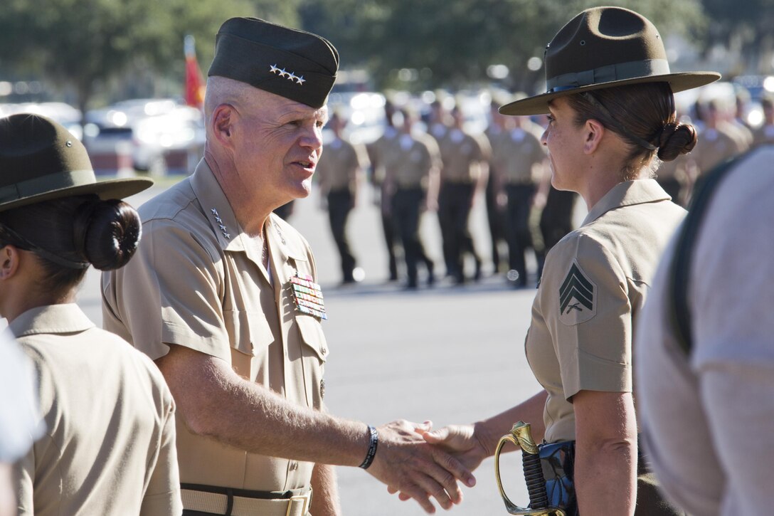 Commandant of the Marine Corps, Gen. Robert B. Neller, left, thanks a Marine drill instructor at a graduation ceremony at Marine Corps Recruit Depot Parris Island, S.C., Oct. 16, 2015. Neller was the parade reviewing official for the ceremony. (U.S. Marine Corps photo by Sgt. Gabriela Garcia/Released)