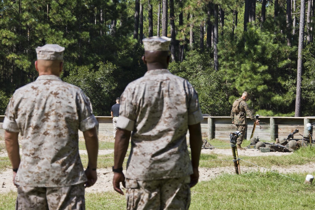 Commandant of the Marine Corps, Gen. Robert B. Neller, left, and Sgt. Maj. of the Marine Corps Ronald L. Green, watch recruits go through the crucible at Marine Corps Recruit Depot Parris Island, S.C., Oct. 16, 2015. Neller and Green watched the recruits go through one of the toughest parts of their recruit training. (U.S. Marine Corps photo by Sgt. Gabriela Garcia/Released)