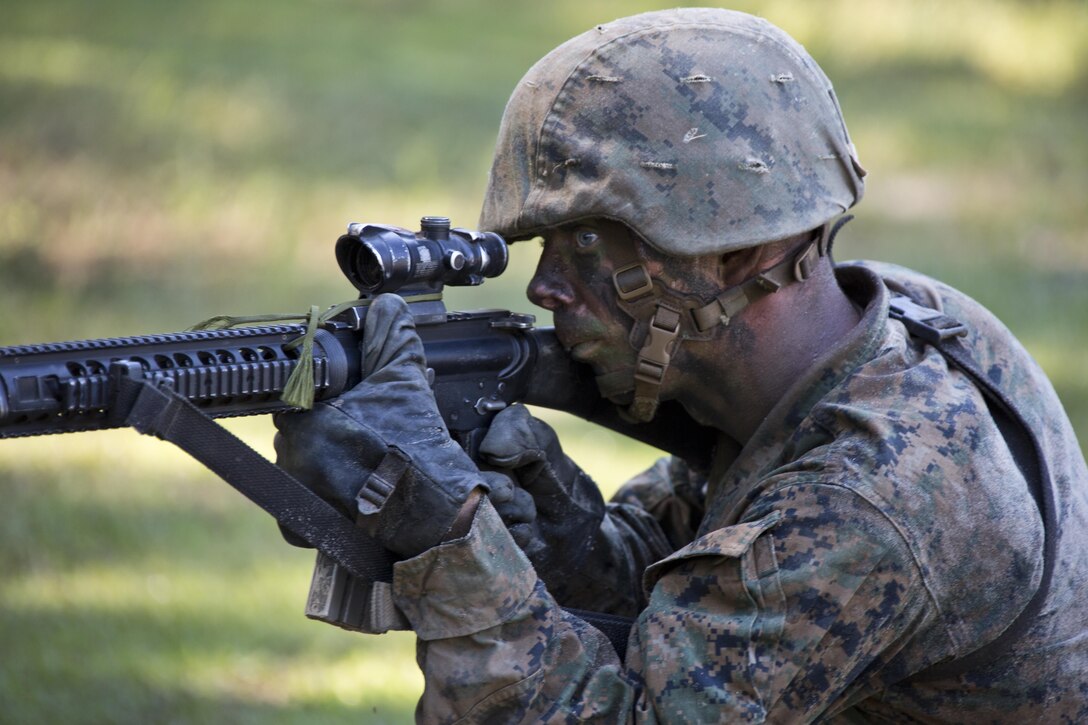 A recruit looks down the scope of his rifle during the crucible at Marine Corps Recruit Depot Parris Island, S.C., Oct. 16, 2015. All Marine Corps recruits must go through the crucible as part of their recruit training. (U.S. Marine Corps photo illustration by Sgt. Gabriela Garcia/Released)