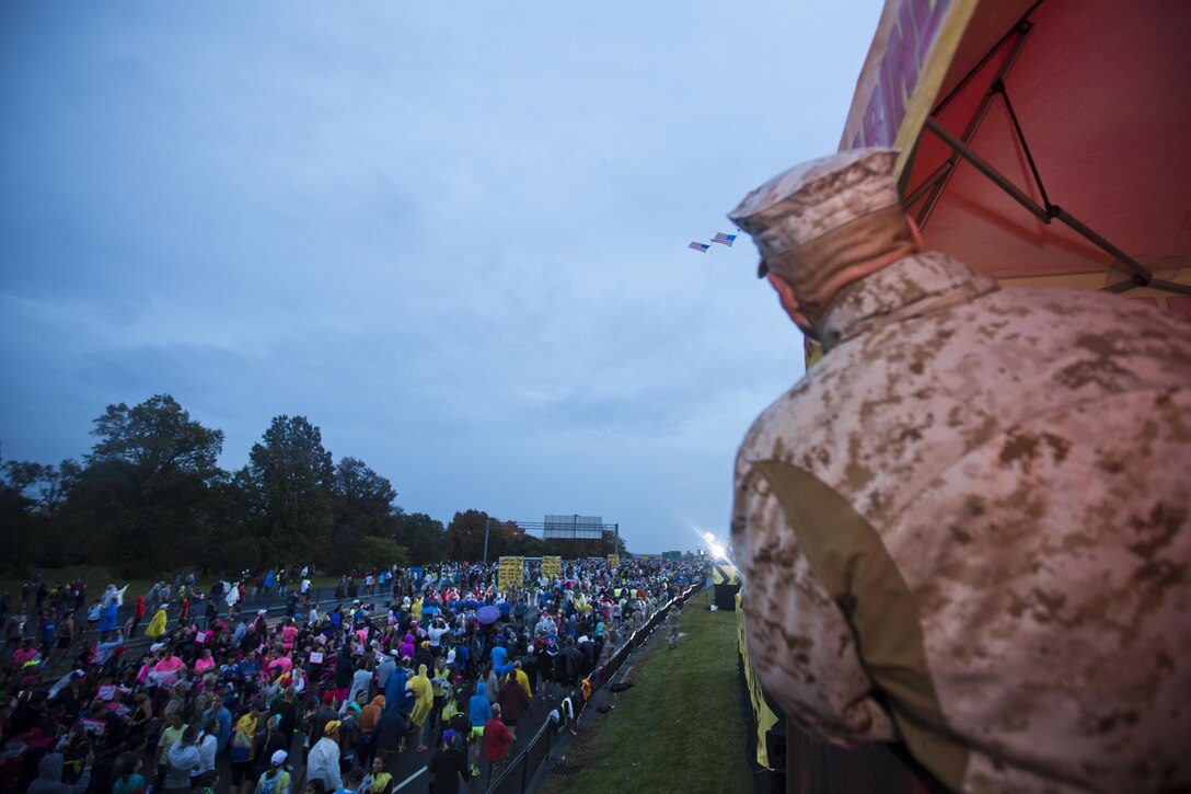 Commandant of the Marine Corps, Gen. Robert B. Neller, observes runners before the Marine Corps Marathon at Arlington, Va., Oct. 25, 2015. Over 30,000 runners participated in the 26.2 mile, 40th annual Marine Corps Marathon. (U.S. Marine Corps photo by Sgt. Gabriela Garcia/Released)