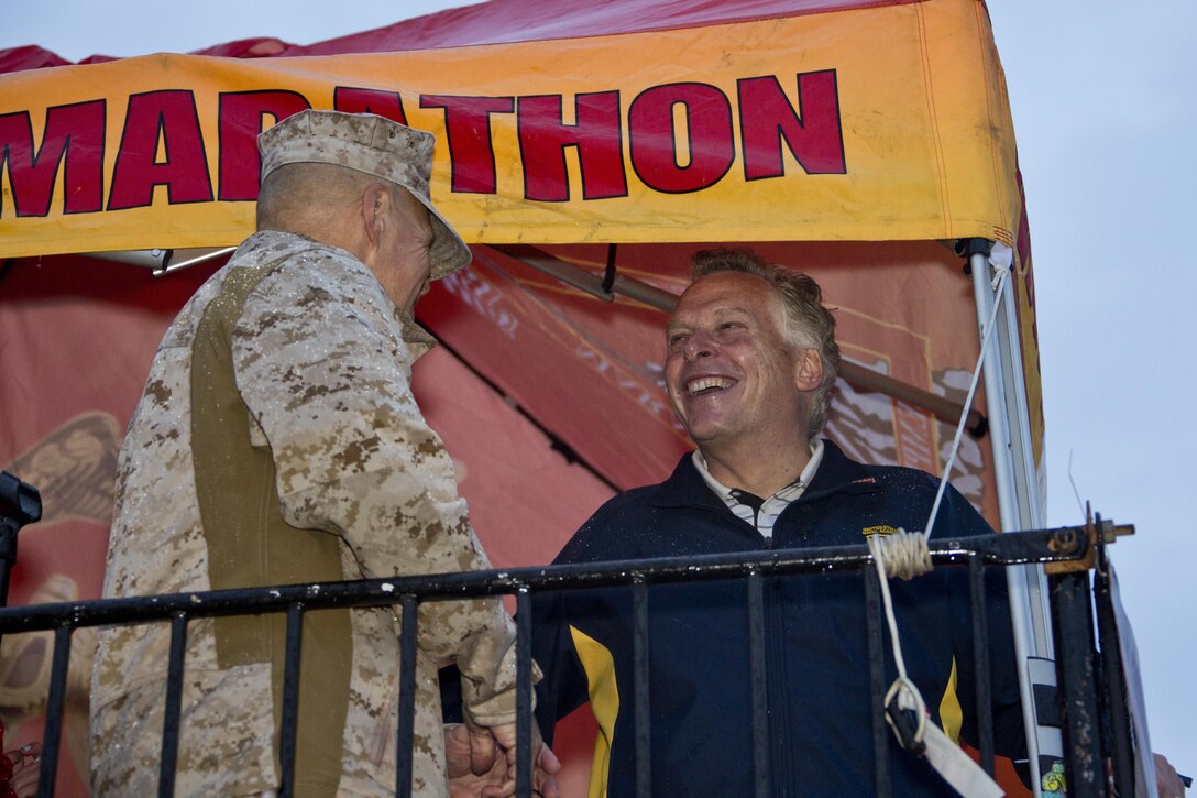 Commandant of the Marine Corps, Gen. Robert B. Neller, talks with Virginia Governor Terry McAuliffe during the Marine Corps Marathon at Arlington, Va., Oct. 25, 2015. Over 30,000 runners participated in the 26.2 mile, 40th annual Marine Corps Marathon. (U.S. Marine Corps photo by Sgt. Gabriela Garcia/Released)