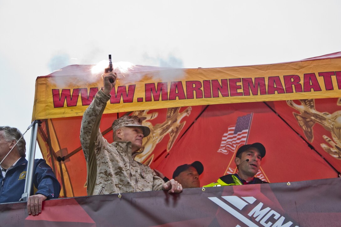 Commandant of the Marine Corps, Gen. Robert B. Neller, fires the starting pistol, initiating the the Marine Corps Marathon at Arlington, Va., Oct. 25, 2015. Over 30,000 runners participated in the 26.2 mile, 40th annual Marine Corps Marathon. (U.S. Marine Corps photo by Sgt. Gabriela Garcia/Released)