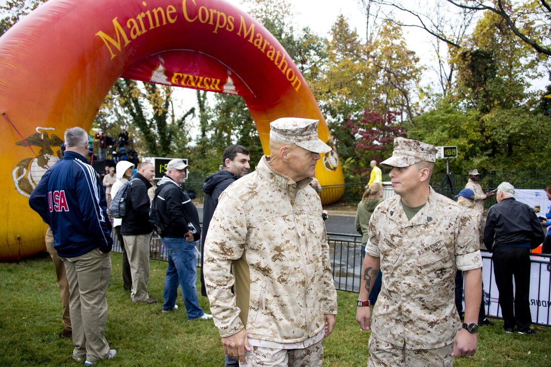 Commandant of the Marine Corps, Gen. Robert B. Neller, talks to a Marine during the Marine Corps Marathon at Arlington, Va., Oct. 25, 2015. Over 30,000 runners participated in the 26.2 mile, 40th annual Marine Corps Marathon. (U.S. Marine Corps photo by Sgt. Gabriela Garcia/Released)