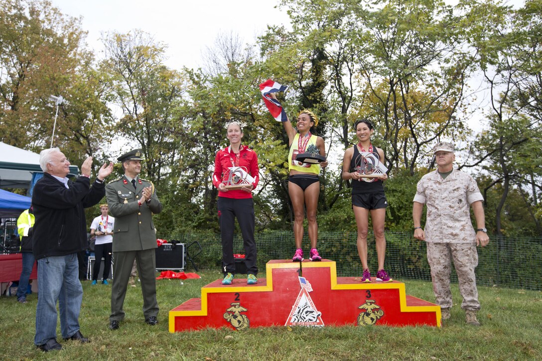 Commandant of the Marine Corps, Gen. Robert B. Neller, poses with the top three women finishers of the Marine Corps Marathon at Arlington, Va., Oct. 25, 2015. Over 30,000 runners participated in the 40th annual Marine Corps Marathon. (U.S. Marine Corps photo by Sgt. Gabriela Garcia/Released)
