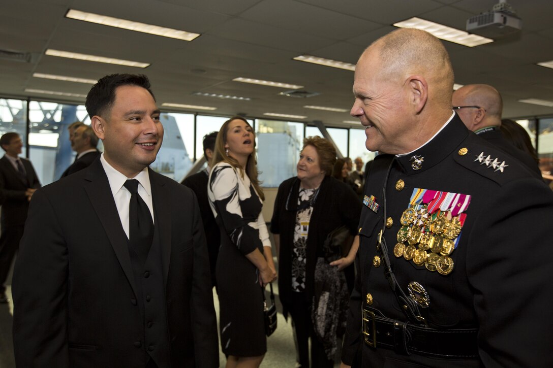 Commandant of the Marine Corps, Gen. Robert B. Neller, right, meets Ricardo Peralta, brother of Marine Corps Sgt. Rafael Peralta, during the USS Rafael Peralta christening ceremony at General Dynamics Bath Iron Works, Bath, Maine, Oct. 31, 2015. The destroyer was named after Sgt. Peralta who was killed during the second battle of Fallujah in 2004. (U.S. Marine Corps photo Sgt. Gabriela Garcia/Released)