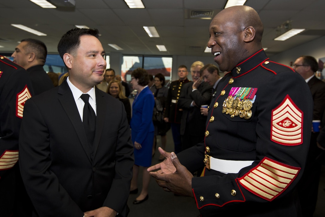 Sgt. Maj. of the Marine Corps Ronald L. Green, right, meets Ricardo Peralta, brother of Marine Corps Sgt. Rafael Peralta, during the USS Rafael Peralta christening ceremony at General Dynamics Bath Iron Works, Bath, Maine, Oct. 31, 2015. The destroyer was named after Sgt. Peralta who was killed during the second battle of Fallujah in 2004. (U.S. Marine Corps photo Sgt. Gabriela Garcia/Released)
