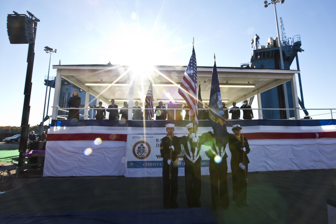 The American and Navy flag are displayed during the USS Rafael Peralta christening ceremony at General Dynamics Bath Iron Works, Bath, Maine, Oct. 31, 2015. The destroyer was named after Marine Corps Sgt. Rafael Peralta who was killed during the second battle of Fallujah in 2004. (U.S. Marine Corps photo Sgt. Gabriela Garcia/Released)