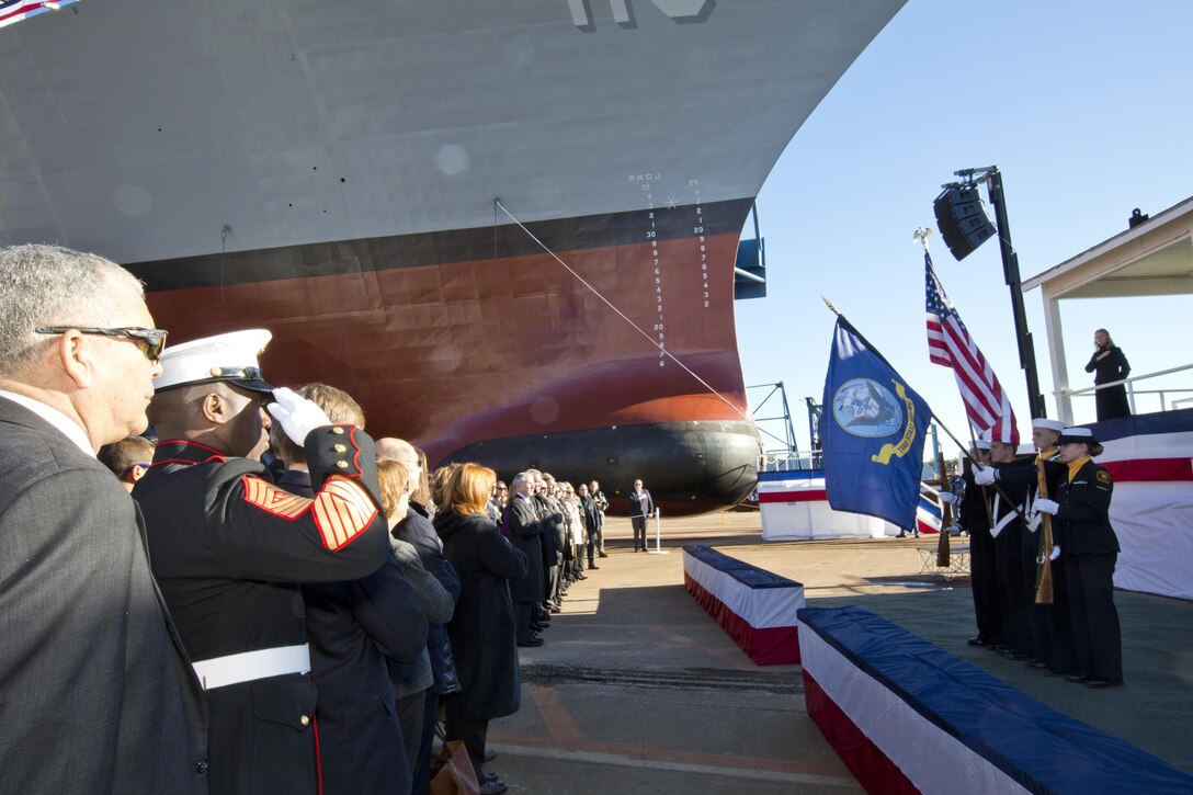 Sgt. Maj. of the Marine Corps Ronald L. Green, second left, salutes during the USS Rafael Peralta christening ceremony at General Dynamics Bath Iron Works, Bath, Maine, Oct. 31, 2015. The destroyer was named after Marine Corps Sgt. Rafael Peralta who was killed during the second battle of Fallujah in 2004. (U.S. Marine Corps photo Sgt. Gabriela Garcia/Released)