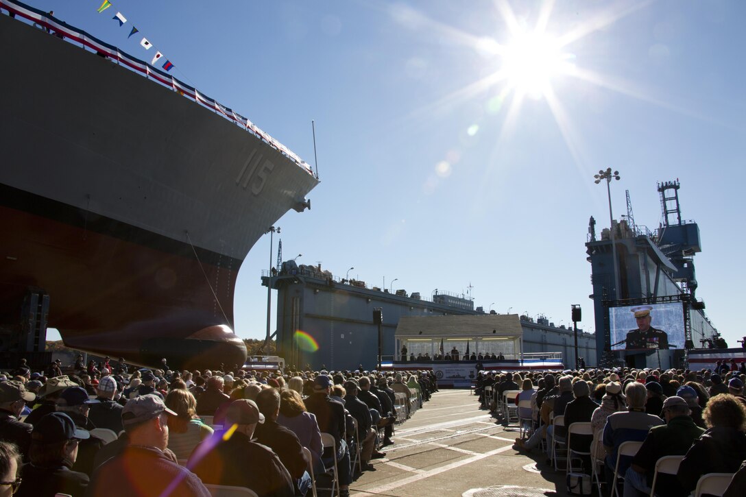 Commandant of the Marine Corps, Gen. Robert B. Neller, center right, speaks during the USS Rafael Peralta christening ceremony at General Dynamics Bath Iron Works, Bath, Maine, Oct. 31, 2015. The destroyer was named after Sgt. Peralta who was killed during the second battle of Fallujah in 2004. (U.S. Marine Corps photo Sgt. Gabriela Garcia/Released)