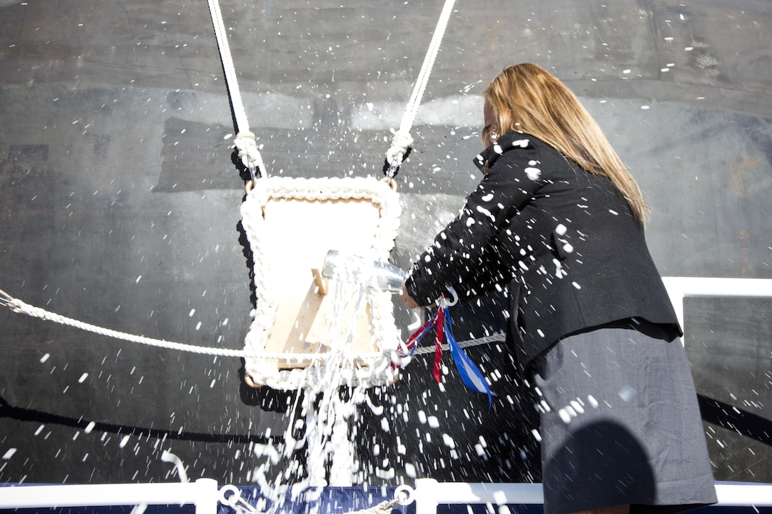Rosa Maria Peralta, mother of Marine Corps Sgt. Rafael Peralta, christens the USS Rafael Peralta at General Dynamics Bath Iron Works, Bath, Maine, Oct. 31, 2015. Peralta was the sponsor and officially christened the destroyer named after her son who was killed during the second battle of Fallujah in 2004. (U.S. Marine Corps photo Sgt. Gabriela Garcia/Released)