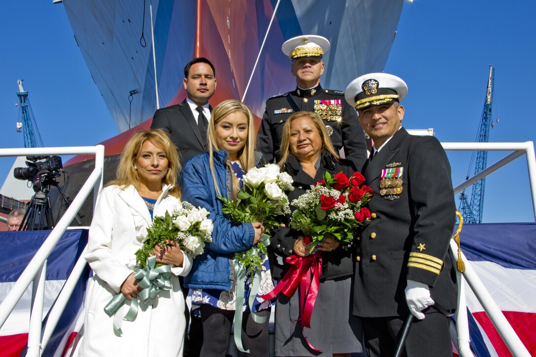 Commandant of the Marine Corps, Gen. Robert B. Neller, top right, poses with Marine Corps Sgt. Rafael Peralta's family members and a Sailor in front of the USS Rafael Peralta at General Dynamics Bath Iron Works, Bath, Maine, Oct. 31, 2015. The destroyer was named after Sgt. Peralta who was killed during the second battle of Fallujah in 2004. (U.S. Marine Corps photo Sgt. Gabriela Garcia/Released)