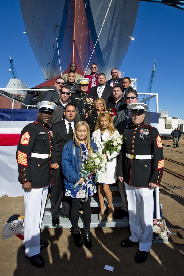 Commandant of the Marine Corps, Gen. Robert B. Neller, third row center, and Sgt. Maj. of the Marine Corps Ronald L. Green, bottom left, pose with Marine Corps Sgt. Rafael Peralta's family members and and friends in front of the USS Rafael Peralta at General Dynamics Bath Iron Works, Bath, Maine, Oct. 31, 2015. The destroyer was named after Sgt. Peralta who was killed during the second battle of Fallujah in 2004. (U.S. Marine Corps photo Sgt. Gabriela Garcia/Released)