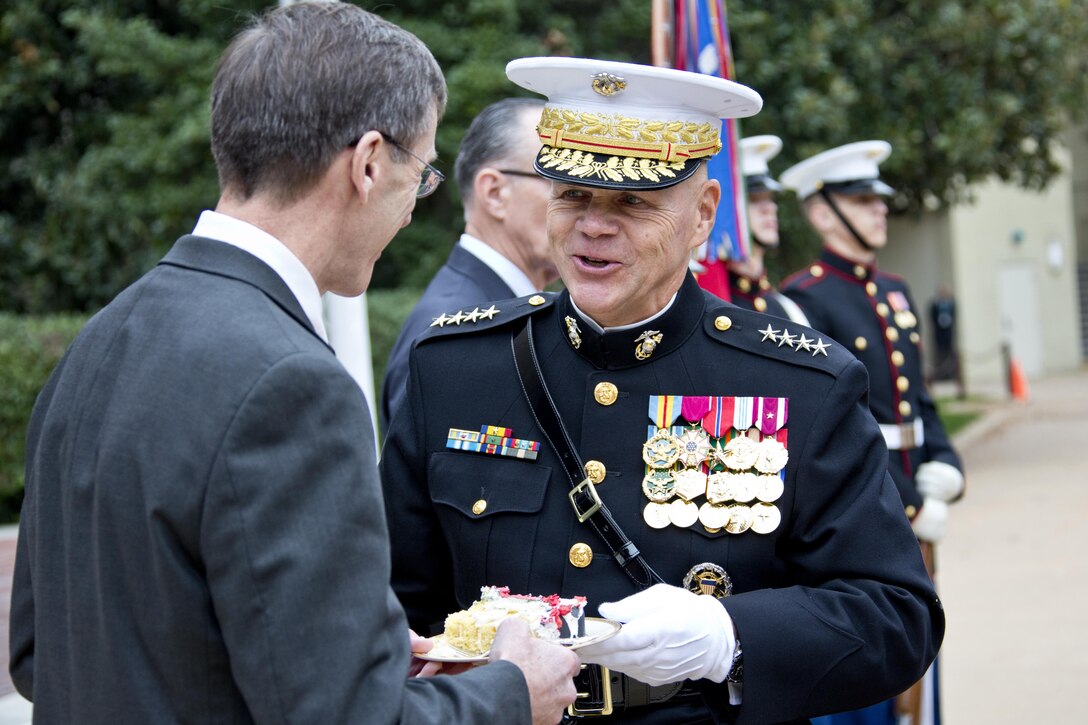 Commandant of the Marine Corps, Gen. Robert B. Neller, right, gives a piece of cake to Sean J. Stackley, the assistant secretary of the Navy research, development and acquisition, during the Pentagon cake cutting ceremony at Washington, D.C., Nov. 9, 2015. The ceremony celebrated the Corps' 240th birthday since it was first established on Nov. 10, 1775. (U.S. Marine Corps photo by Sgt. Gabriela Garcia/Released)