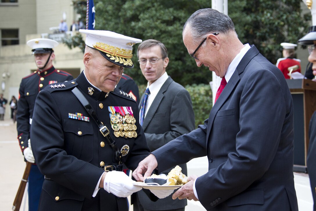 Commandant of the Marine Corps, Gen. Robert B. Neller, left, gives a piece of cake to retired U.S. Marine Corps Col. Jan Durham, the oldest Marine during the Pentagon cake cutting ceremony at Washington, D.C., Nov. 9, 2015. The ceremony celebrated the Corps' 240th birthday since it was first established on Nov. 10, 1775. (U.S. Marine Corps photo by Sgt. Gabriela Garcia/Released)