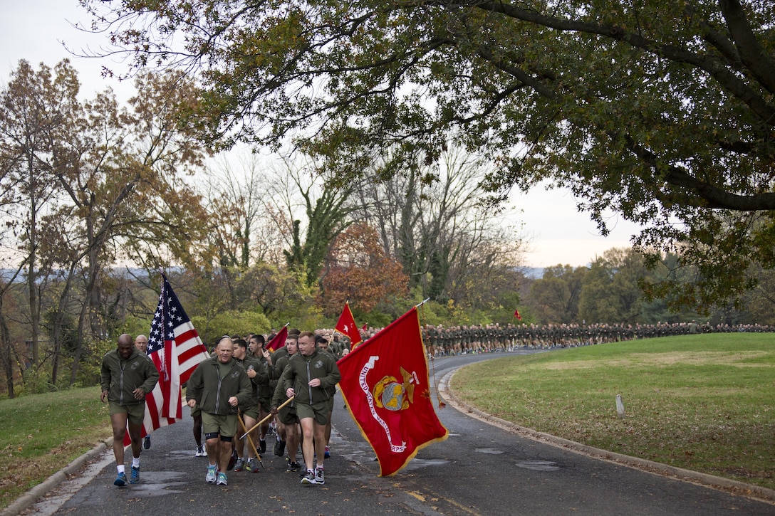 Commandant of the Marine Corps, Gen. Robert B. Neller, center, runs with Sgt. Maj. of the Marine Corps Ronald L. Green, left, Marines and Sailors at Arlington, Va., Nov. 12, 2015. Neller and Green led Marines and Sailors on a Marine Corps birthday run from the Pentagon to the Marine Corps War Memorial. (U.S. Marine Corps photo by Staff Sgt. Gabriela Garcia/Released)