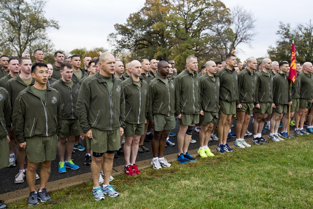 Commandant of the Marine Corps, Gen. Robert B. Neller, sings the Marines' Hymn with Marines and Sailors at Arlington, Va., Nov. 12, 2015. Neller led Marines and Sailors on a Marine Corps birthday run from the Pentagon to the Marine Corps War Memorial. (U.S. Marine Corps photo by Staff Sgt. Gabriela Garcia/Released)