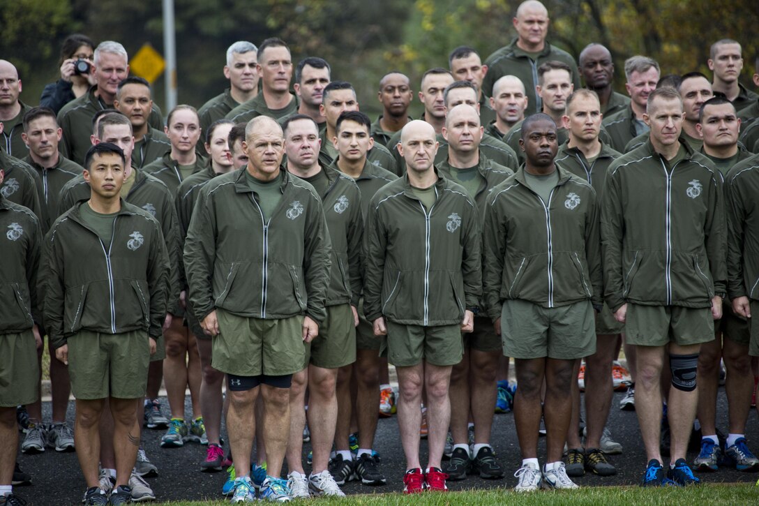 Commandant of the Marine Corps, Gen. Robert B. Neller, sings the Marines' Hymn with Marines and Sailors at Arlington, Va., Nov. 12, 2015. Neller led Marines and Sailors on a Marine Corps birthday run from the Pentagon to the Marine Corps War Memorial. (U.S. Marine Corps photo by Staff Sgt. Gabriela Garcia/Released)