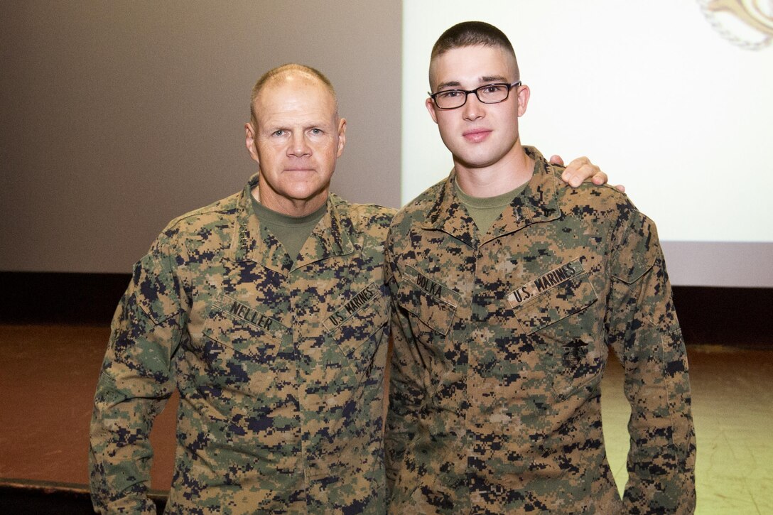 Commandant of the Marine Corps, Gen. Robert B. Neller, left, poses next to Cpl. Nathan S. Bolka with Headquarters Battalion, at Marine Corps Base, Hawaii, Nov. 20, 2015. Neller promoted Bolka from the rank of lance corporal during his Hawaii visit. (U.S. Marine Corps photo by Staff Sgt. Gabriela Garcia/Released)