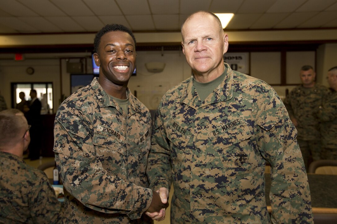 Commandant of the Marine Corps, Gen. Robert B. Neller, poses with a Marine inside the mess hall at Marine Corps Base, Hawaii, Nov. 20, 2015. Neller visited with Marines to outline the Corps current priorities, expectations. (U.S. Marine Corps photo by Staff Sgt. Gabriela Garcia/Released)