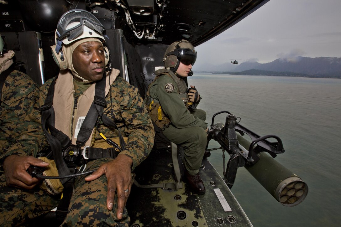 Sgt. Maj. of the Marine Corps Ronald L. Green, left, and Sgt. Ryan S. Kidd, a weapons and tactics instructor with Marine Light Attack Helicopter Squadron 367, look outside a UH-1Y huey aircraft over Hawaii, Nov. 20, 2015. Green toured Oahu facilities during a Hawaii visit with Commandant of the Marine Corps, Gen. Robert B. Neller. (U.S. Marine Corps photo by Staff Sgt. Gabriela Garcia/Released)