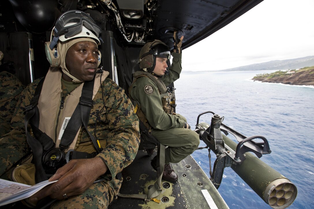 Sgt. Maj. of the Marine Corps Ronald L. Green, left, and Sgt. Ryan S. Kidd, a weapons and tactics instructor with Marine Light Attack Helicopter Squadron 367, look outside a UH-1Y huey aircraft over Hawaii, Nov. 20, 2015. Green toured Oahu facilities during a Hawaii visit with Commandant of the Marine Corps, Gen. Robert B. Neller. (U.S. Marine Corps photo by Staff Sgt. Gabriela Garcia/Released)