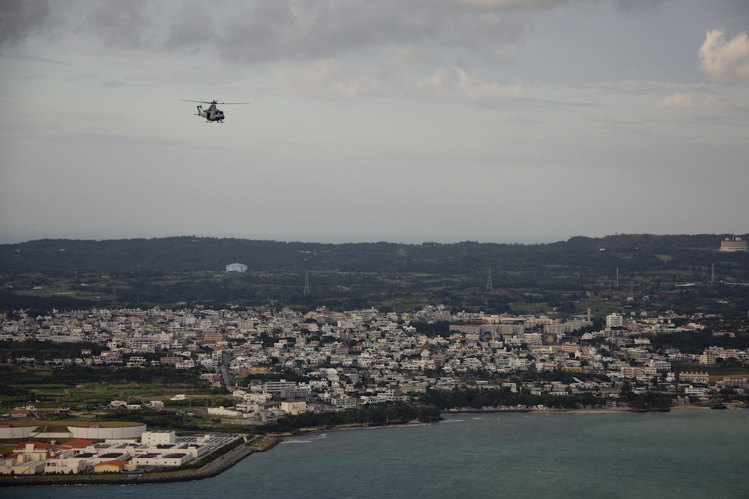 A UH-1Y Huey aircraft with Marine Light Attack Helicopter Squadron 167, flies over Okinawa, Japan, Nov. 23, 2015. The unit supported the Commandant of the Marine Corps, Gen. Robert B. Neller, and Sgt. Maj. of the Marine Corps Ronald L. Green with transportation during their Okinawa visit with Marines. (U.S. Marine Corps photo by Staff Sgt. Gabriela Garcia/Released)