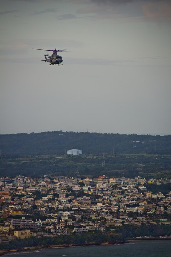 A UH-1Y Huey aircraft with Marine Light Attack Helicopter Squadron 167, flies over Okinawa, Japan, Nov. 23, 2015. The unit supported the Commandant of the Marine Corps, Gen. Robert B. Neller, and Sgt. Maj. of the Marine Corps Ronald L. Green with transportation during their Okinawa visit with Marines. (U.S. Marine Corps photo by Staff Sgt. Gabriela Garcia/Released)