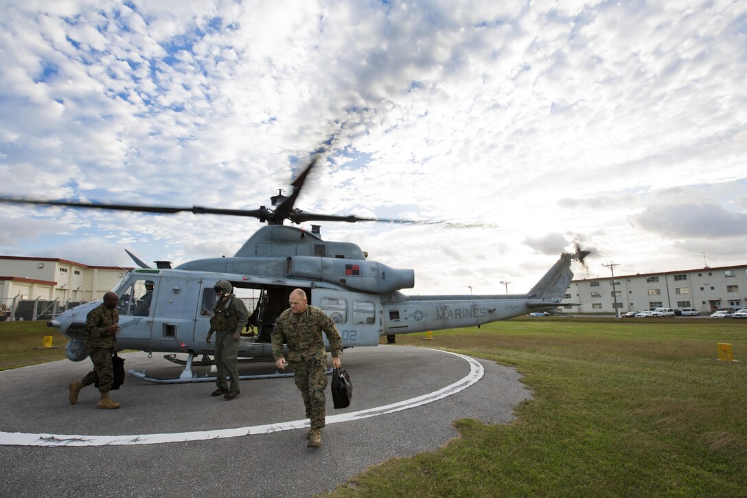 Commandant of the Marine Corps, Gen. Robert B. Neller, walks out of a UH-1Y Huey aircraft with Marine Light Attack Helicopter Squadron 167, during his visit with Marines at Kadena Air Force Base, Okinawa, Japan, Nov. 23, 2015. Neller visited with Marines to outline the Corps' current priorities, expectations, and answer Marines' questions. (U.S. Marine Corps photo by Staff Sgt. Gabriela Garcia/Released)