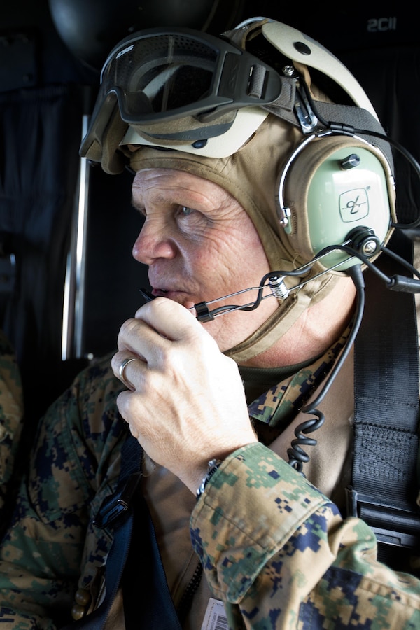 Commandant of the Marine Corps, Gen. Robert B. Neller, talks inside a UH-1Y Huey aircraft with Marine Light Attack Helicopter Squadron 167, during his visit with Marines at Kadena Air Force Base, Okinawa, Japan, Nov. 23, 2015. Neller visited with Marines to outline the Corps' current priorities, expectations, and answer Marines' questions. (U.S. Marine Corps photo by Staff Sgt. Gabriela Garcia/Released)