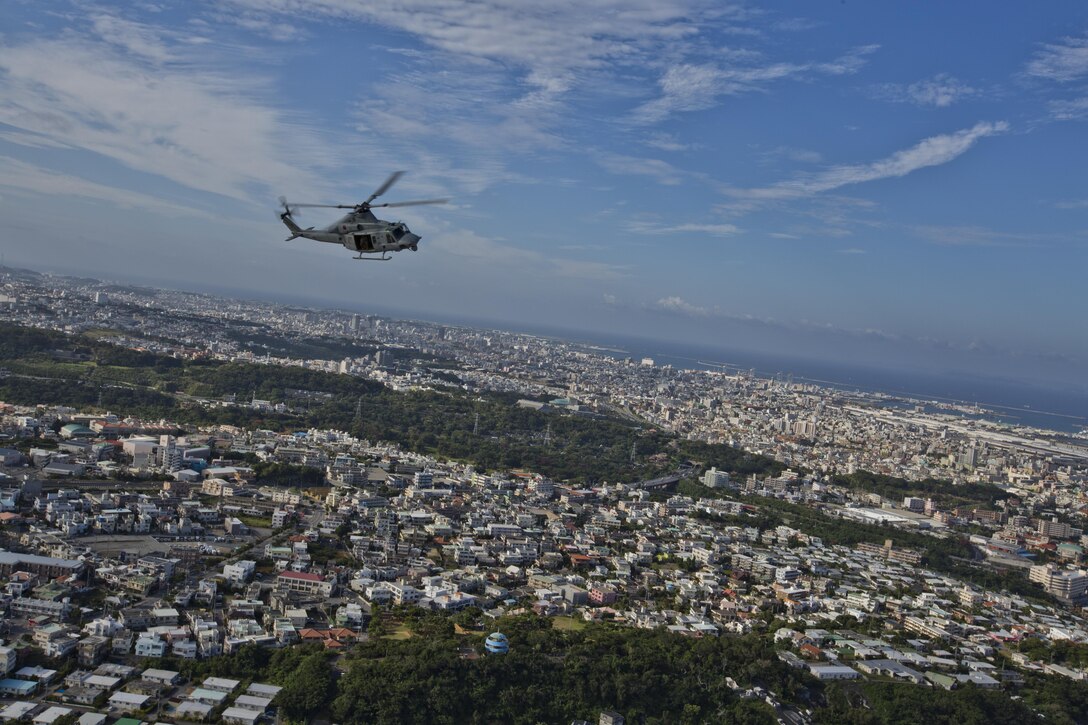 A UH-1Y Huey aircraft with Marine Light Attack Helicopter Squadron 167, flies over Okinawa, Japan, Nov. 23, 2015. The unit supported the Commandant of the Marine Corps, Gen. Robert B. Neller, and Sgt. Maj. of the Marine Corps Ronald L. Green with transportation during their Okinawa visit with Marines. (U.S. Marine Corps photo by Staff Sgt. Gabriela Garcia/Released)
