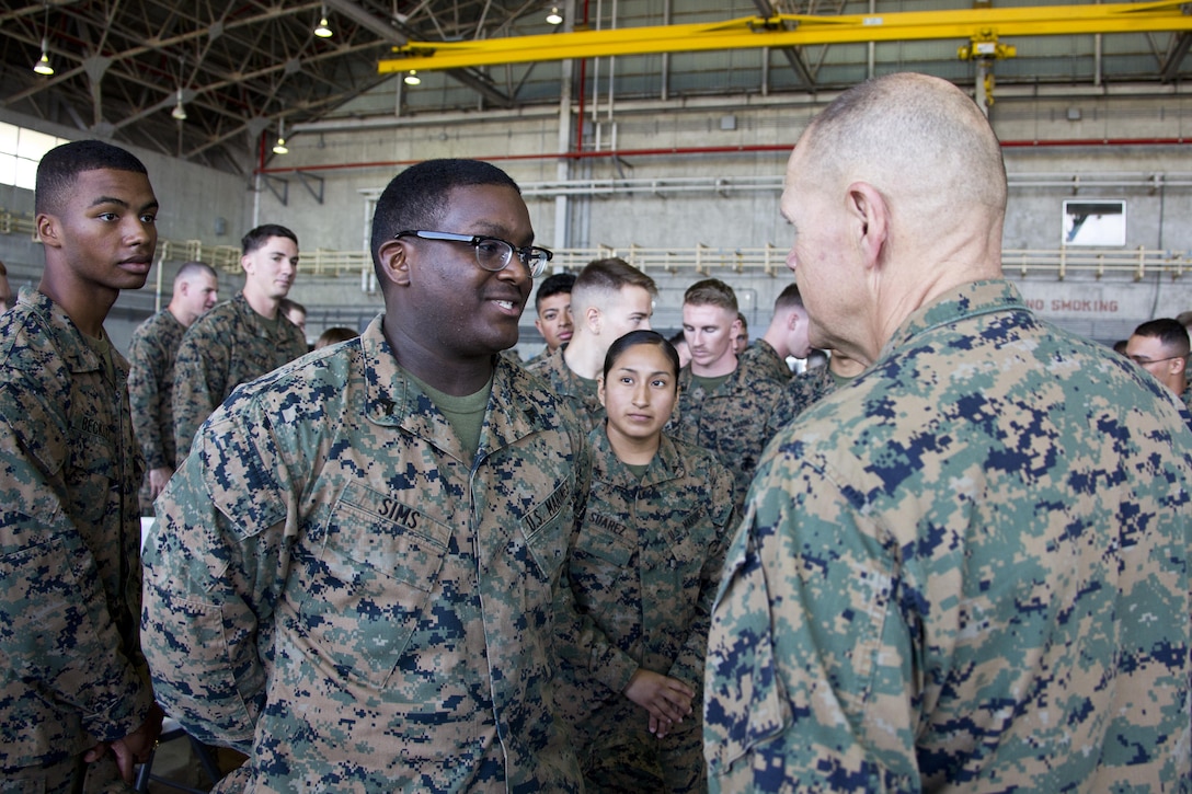 Commandant of the Marine Corps, Gen. Robert B. Neller, right, speaks with Marines at Marine Corps Air Station Futenma, Okinawa, Japan, Nov. 23, 2015. Neller visited with Marines to outline the Corps' current priorities, expectations, and answer Marines' questions. (U.S. Marine Corps photo by Staff Sgt. Gabriela Garcia/Released)