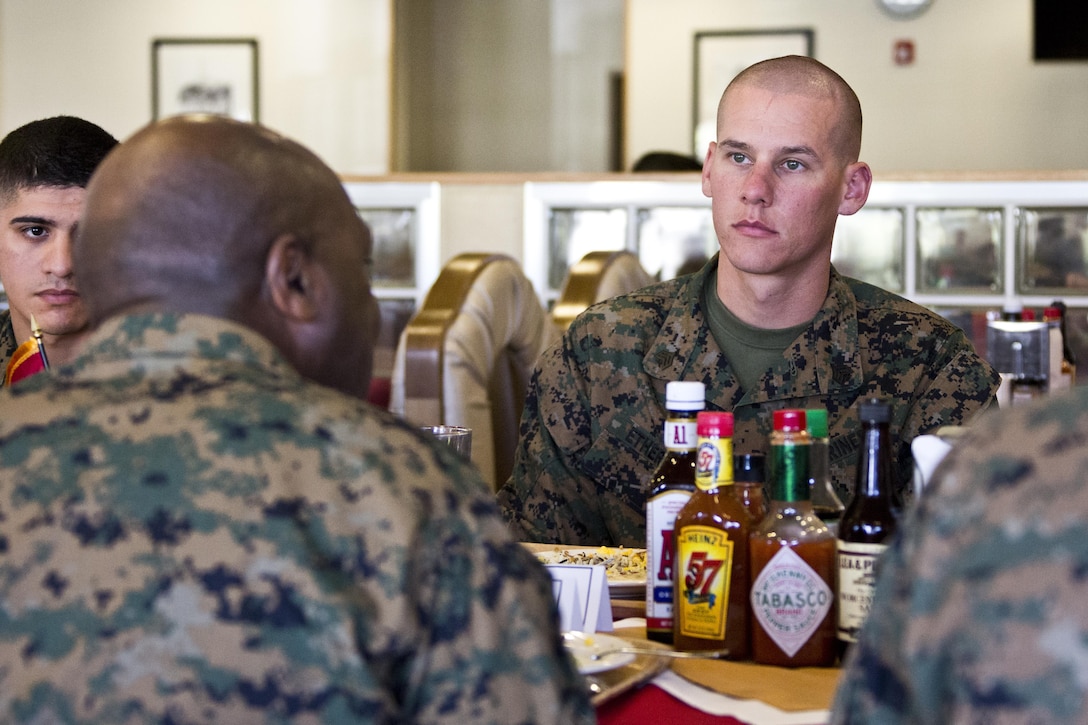 Marines listen to Sgt. Maj. of the Marine Corps Ronald L. Green, left, at Camp Foster, Okinawa, Japan, Nov. 23, 2015. Commandant of the Marine Corps, Gen. Robert B. Neller and Green had lunch with Marines during their Okinawa visit. (U.S. Marine Corps photo by Staff Sgt. Gabriela Garcia/Released)