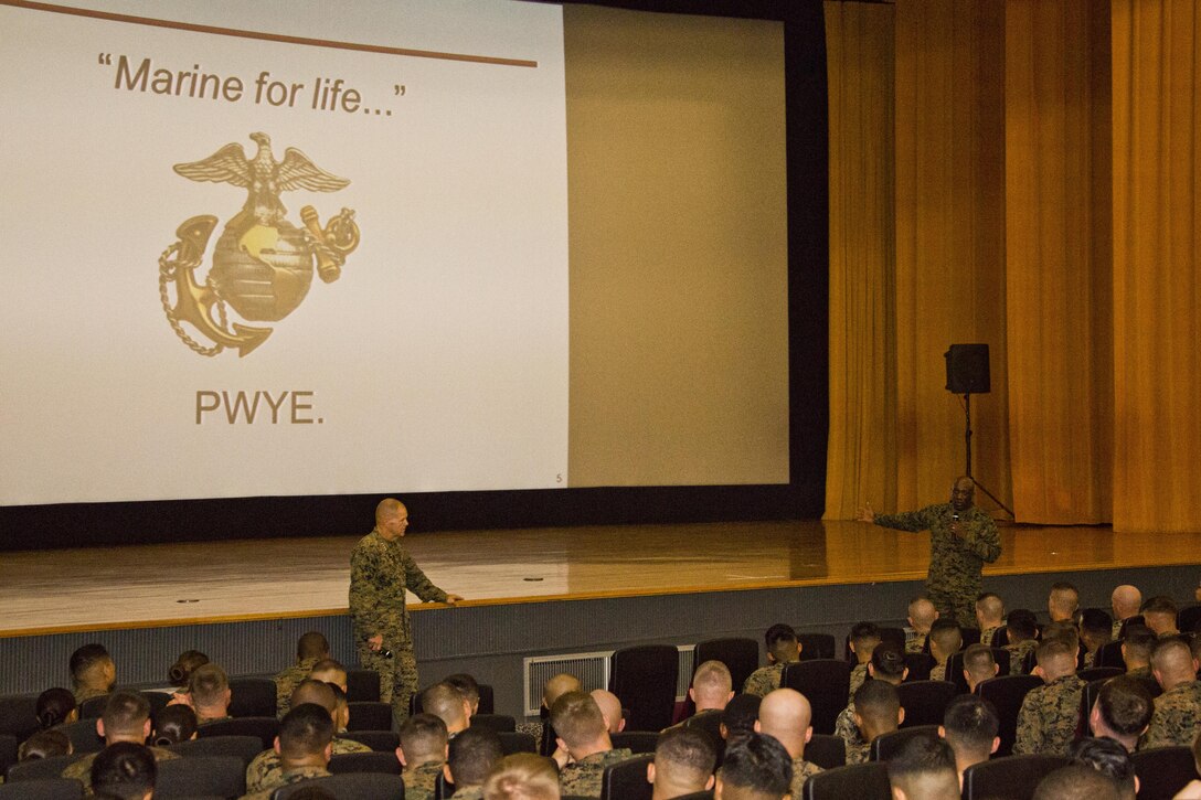 Commandant of the Marine Corps, Gen. Robert B. Neller, left, listens to Sgt. Maj. of the Marine Corps Ronald L. Green speak with Marines at Camp Foster, Okinawa, Japan, Nov. 23, 2015. Neller and Green outlined the Corps' current priorities, expectations, listened and answered Marines' questions. (U.S. Marine Corps photo by Staff Sgt. Gabriela Garcia/Released)