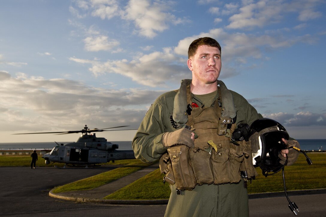 U.S. Marine Corps Sgt. Donald J. Anderson, a crew chief with Marine Light Attack Helicopter Squadron 167, waits for Commandant of the Marine Corps, Gen. Robert B. Neller, and Sgt. Maj. of the Marine Corps Ronald L. Green at Okinawa, Japan, Nov. 23, 2015. The unit supported the Commandant of the Marine Corps, Gen. Robert B. Neller, and Sgt. Maj. of the Marine Corps Ronald L. Green with transportation during their Okinawa visit with Marines. (U.S. Marine Corps photo by Staff Sgt. Gabriela Garcia/Released)