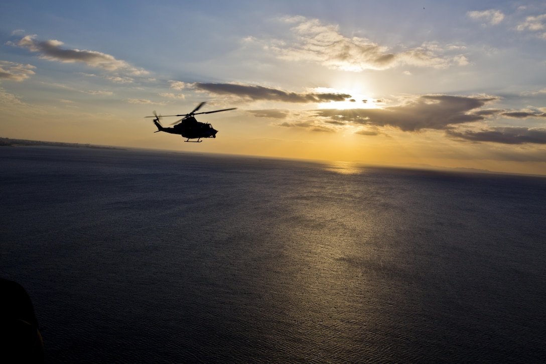A UH-1Y Huey aircraft with Marine Light Attack Helicopter Squadron 167, flies over Okinawa, Japan, Nov. 23, 2015. The unit supported the Commandant of the Marine Corps, Gen. Robert B. Neller, and Sgt. Maj. of the Marine Corps Ronald L. Green with transportation during their Okinawa visit with Marines. (U.S. Marine Corps photo by Staff Sgt. Gabriela Garcia/Released)