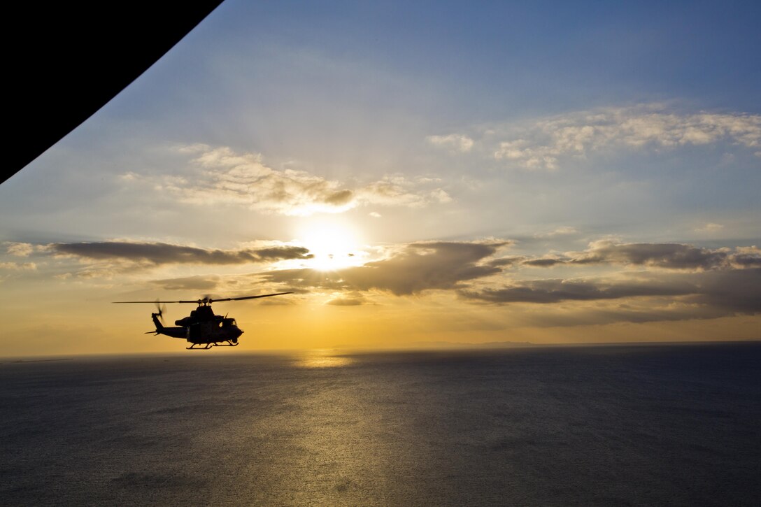 A UH-1Y Huey aircraft with Marine Light Attack Helicopter Squadron 167, flies over Okinawa, Japan, Nov. 23, 2015. The unit supported the Commandant of the Marine Corps, Gen. Robert B. Neller, and Sgt. Maj. of the Marine Corps Ronald L. Green with transportation during their Okinawa visit with Marines. (U.S. Marine Corps photo by Staff Sgt. Gabriela Garcia/Released)