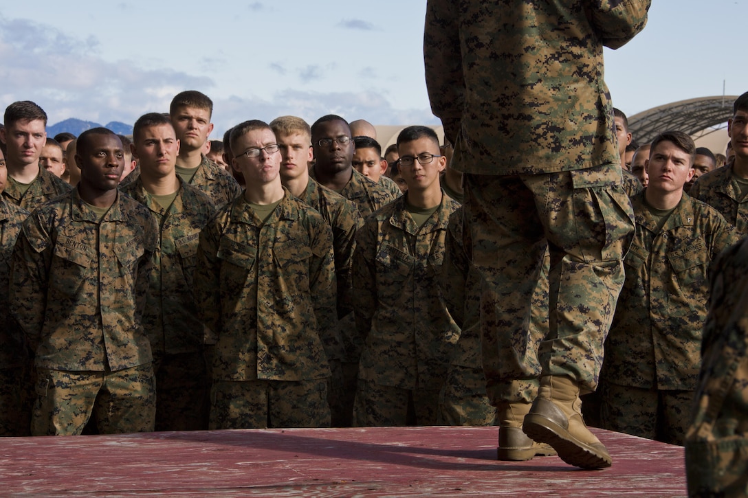 U.S. Marines listen to Commandant of the Marine Corps, Gen. Robert B. Neller speak at Marine Corps Air Station Iwakuni, Okinawa, Japan, Nov. 24, 2015. Neller and Sgt. Maj. of the Marine Corps Ronald L. Green visited Marines to outline the Corps' current priorities, expectations, and answer questions. (U.S. Marine Corps photo by Staff Sgt. Gabriela Garcia/Released)