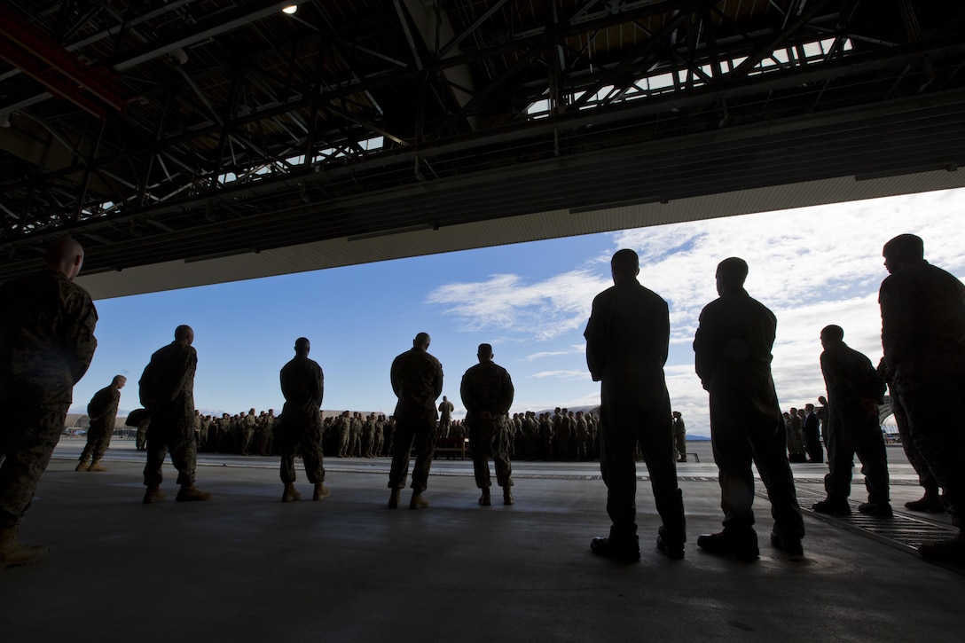 U.S. Marines listen to Commandant of the Marine Corps, Gen. Robert B. Neller speak at Marine Corps Air Station Iwakuni, Okinawa, Japan, Nov. 24, 2015. Neller and Sgt. Maj. of the Marine Corps Ronald L. Green visited Marines to outline the Corps' current priorities, expectations, and answer questions. (U.S. Marine Corps photo by Staff Sgt. Gabriela Garcia/Released)