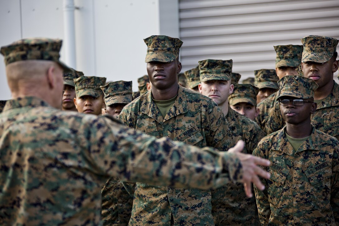 U.S. Marines listen to Commandant of the Marine Corps, Gen. Robert B. Neller speak at Marine Corps Air Station Iwakuni, Okinawa, Japan, Nov. 24, 2015. Neller and Sgt. Maj. of the Marine Corps Ronald L. Green visited Marines to outline the Corps' current priorities, expectations, and answer questions. (U.S. Marine Corps photo by Staff Sgt. Gabriela Garcia/Released)