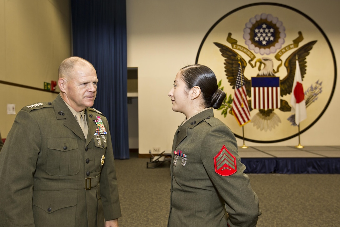 Commandant of the Marine Corps, Gen. Robert B. Neller reenlists Sgt. Miriam M. Ramos, a Marine security guard, at Tokyo, Japan, Nov. 25, 2015. Neller reenlisted Ramos during his Japan visit with Sgt. Maj. of the Marine Corps Ronald L. Green. (U.S. Marine Corps photo by Staff Sgt. Gabriela Garcia/Released)