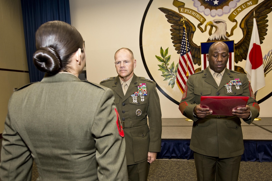 Sgt. Maj. of the Marine Corps Ronald L. Green, right, reads a warrant next to Commandant of the Marine Corps, Gen. Robert B. Neller, center, and Sgt. Miriam M. Ramos, a Marine security guard, at Tokyo, Japan, Nov. 25, 2015. Neller reenlisted Ramos during his Japan visit with Sgt. Maj. of the Marine Corps Ronald L. Green. (U.S. Marine Corps photo by Staff Sgt. Gabriela Garcia/Released)