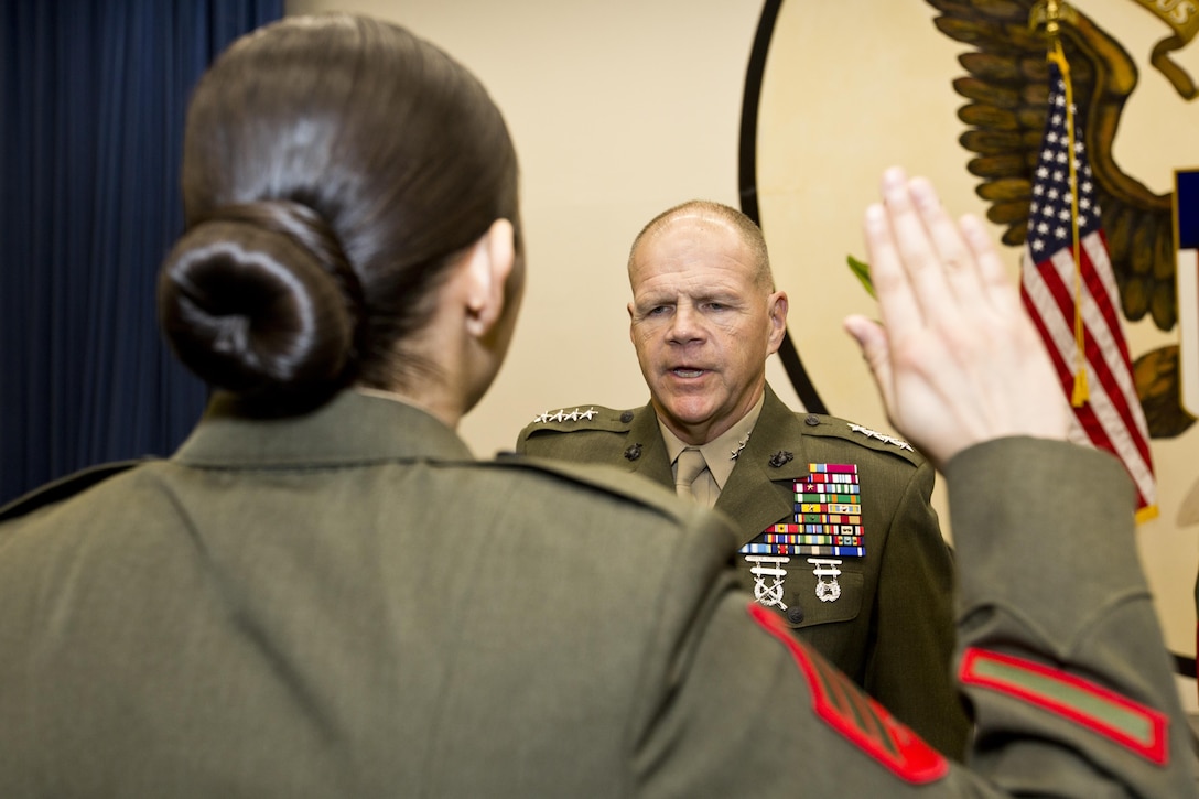 Commandant of the Marine Corps, Gen. Robert B. Neller reenlists Sgt. Miriam M. Ramos, a Marine security guard, at Tokyo, Japan, Nov. 25, 2015. Neller reenlisted Ramos during his Japan visit with Sgt. Maj. of the Marine Corps Ronald L. Green. (U.S. Marine Corps photo by Staff Sgt. Gabriela Garcia/Released)