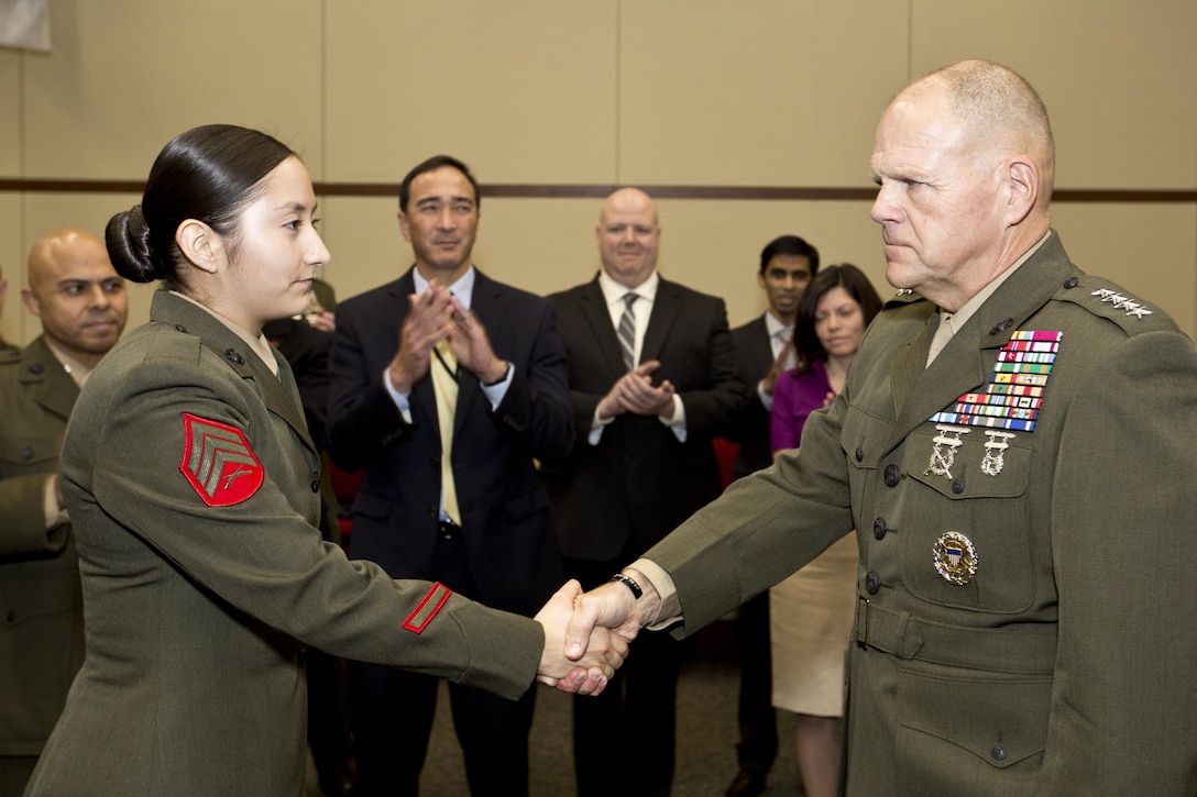 Commandant of the Marine Corps, Gen. Robert B. Neller congratulates Sgt. Miriam M. Ramos, a Marine security guard, at Tokyo, Japan, Nov. 25, 2015. Neller reenlisted Ramos during his Japan visit with Sgt. Maj. of the Marine Corps Ronald L. Green. (U.S. Marine Corps photo by Staff Sgt. Gabriela Garcia/Released)