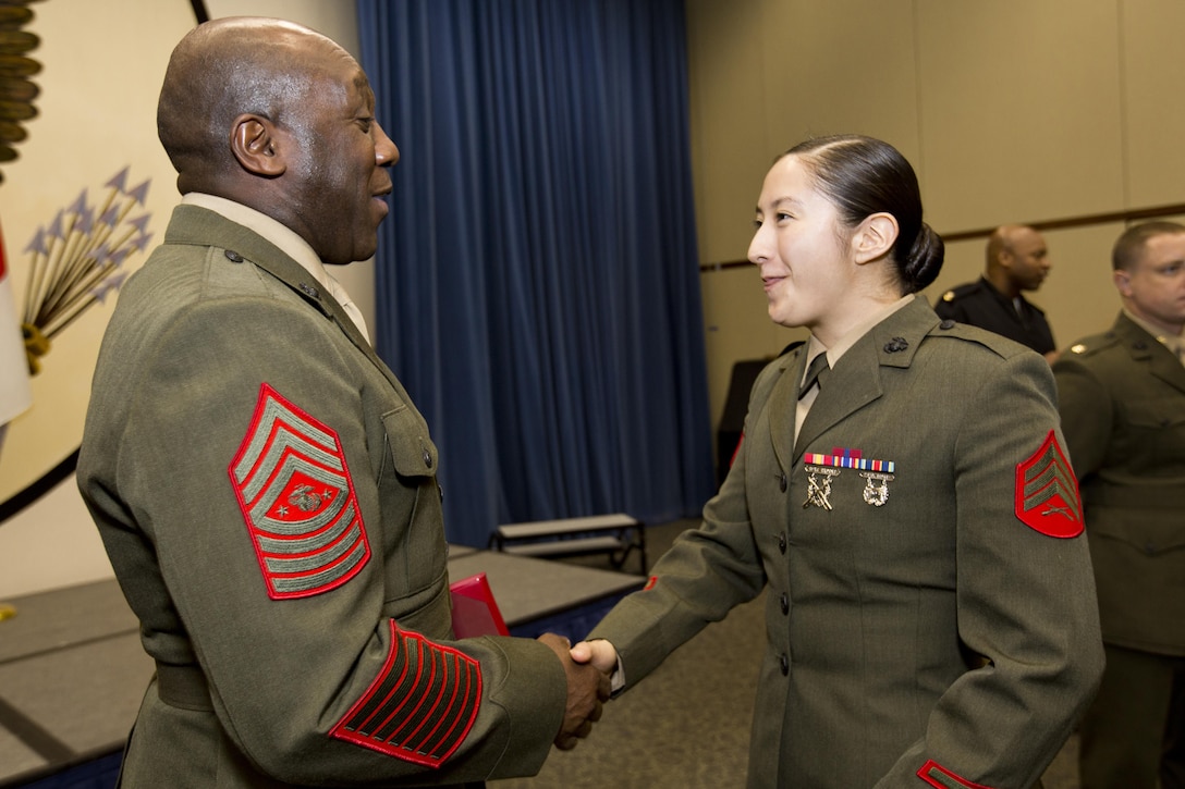 Sgt. Maj. of the Marine Corps Ronald L. Green congratulates Sgt. Miriam M. Ramos, a Marine security guard, at Tokyo, Japan, Nov. 25, 2015. Commandant of the Marine Corps, Gen. Robert B. Neller reenlisted Ramos during his Japan visit with Green. (U.S. Marine Corps photo by Staff Sgt. Gabriela Garcia/Released)