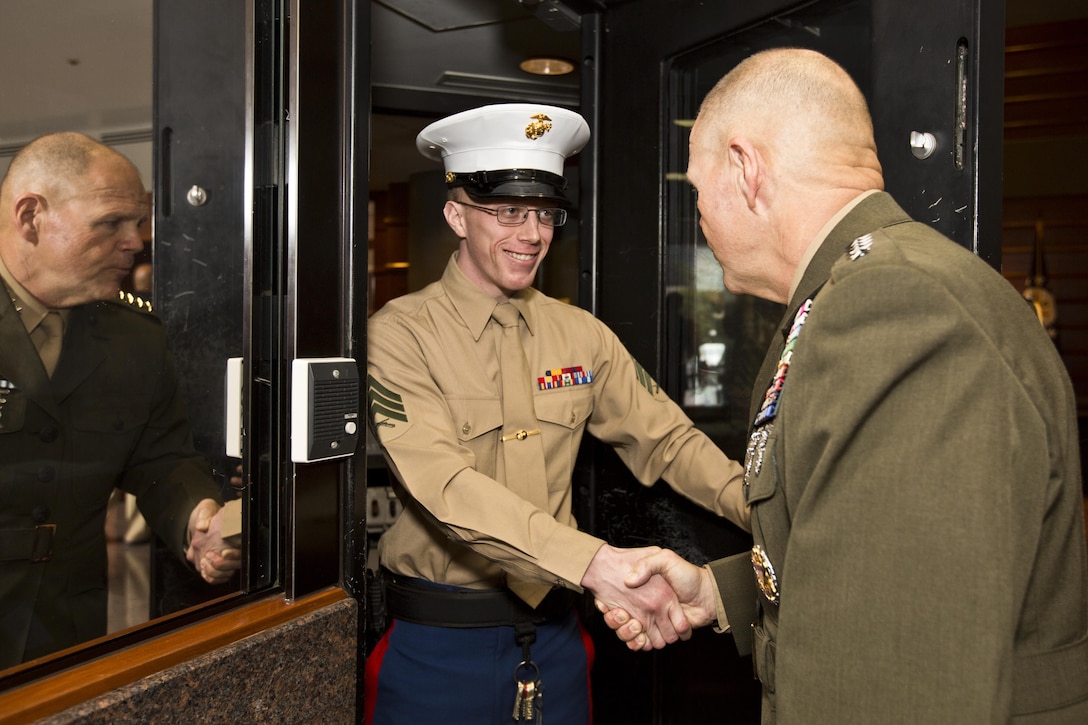 Commandant of the Marine Corps, Gen. Robert B. Neller greets a Marine security guard at Tokyo, Japan, Nov. 25, 2015. Neller reenlisted a Marine security guard and met with them during his Japan visit with Sgt. Maj. of the Marine Corps Ronald L. Green. (U.S. Marine Corps photo by Staff Sgt. Gabriela Garcia/Released)
