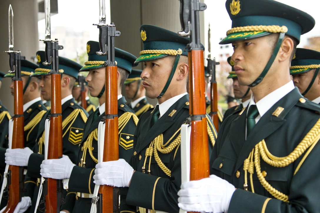 Japanese service members perform a Guard of Honor ceremony at Tokyo, Japan, Nov. 25, 2015. The ceremony was held in honor of Commandant of the Marine Corps, Gen. Robert B. Neller during his Japan visit. (U.S. Marine Corps photo by Staff Sgt. Gabriela Garcia/Released)